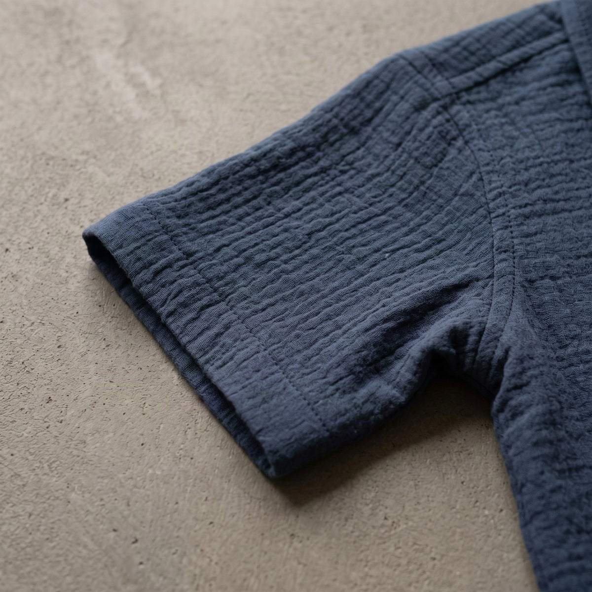 Denim blue muslin shirt sleeve close-up